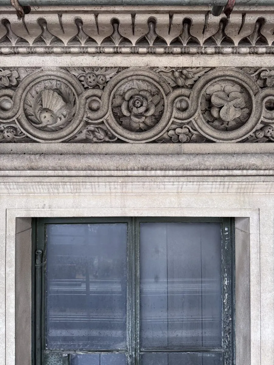 Portland stone frieze before cleaning, heavily soiled